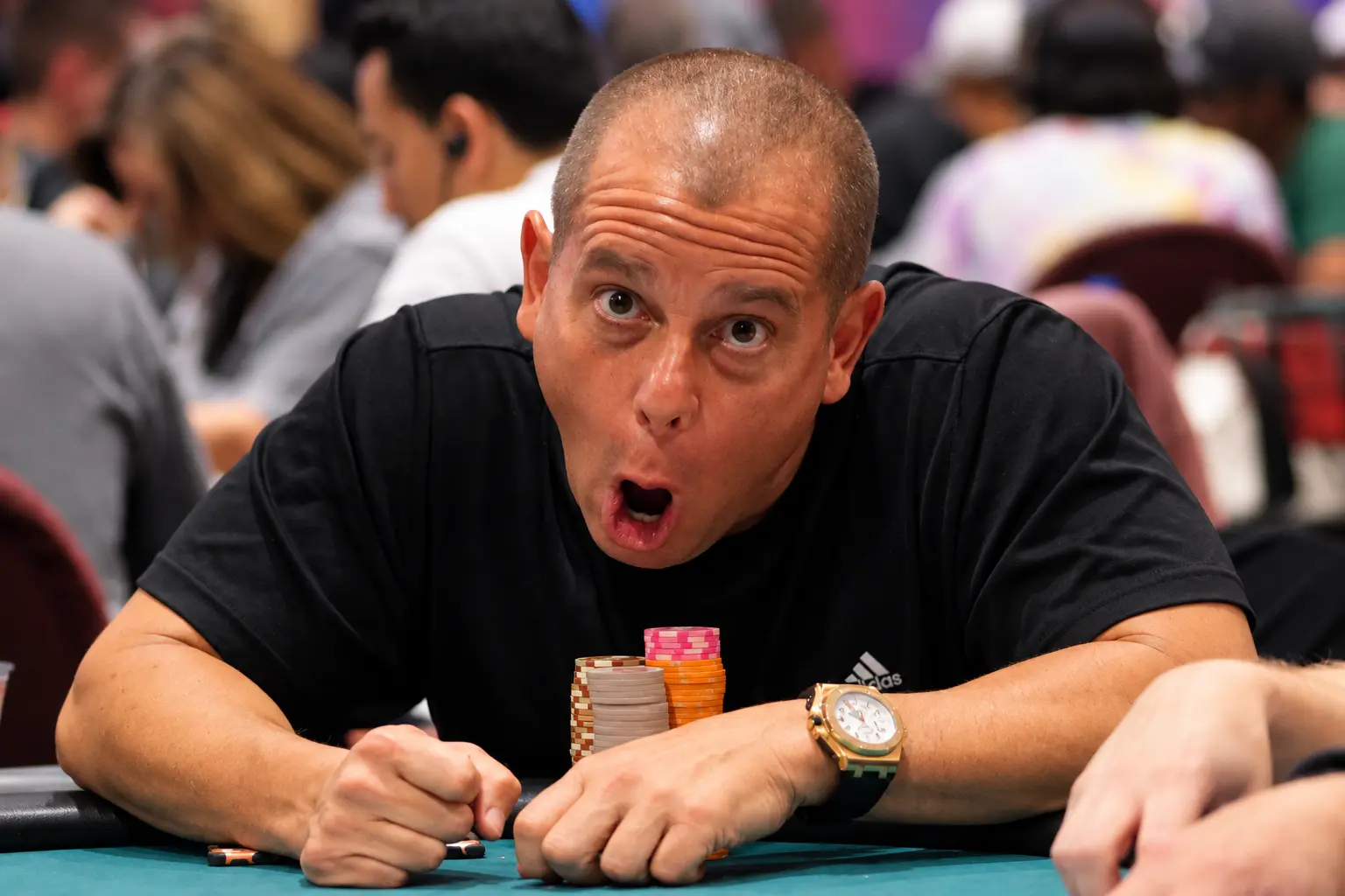 Will Failla leaning toward the camera with a playful expression at the table.